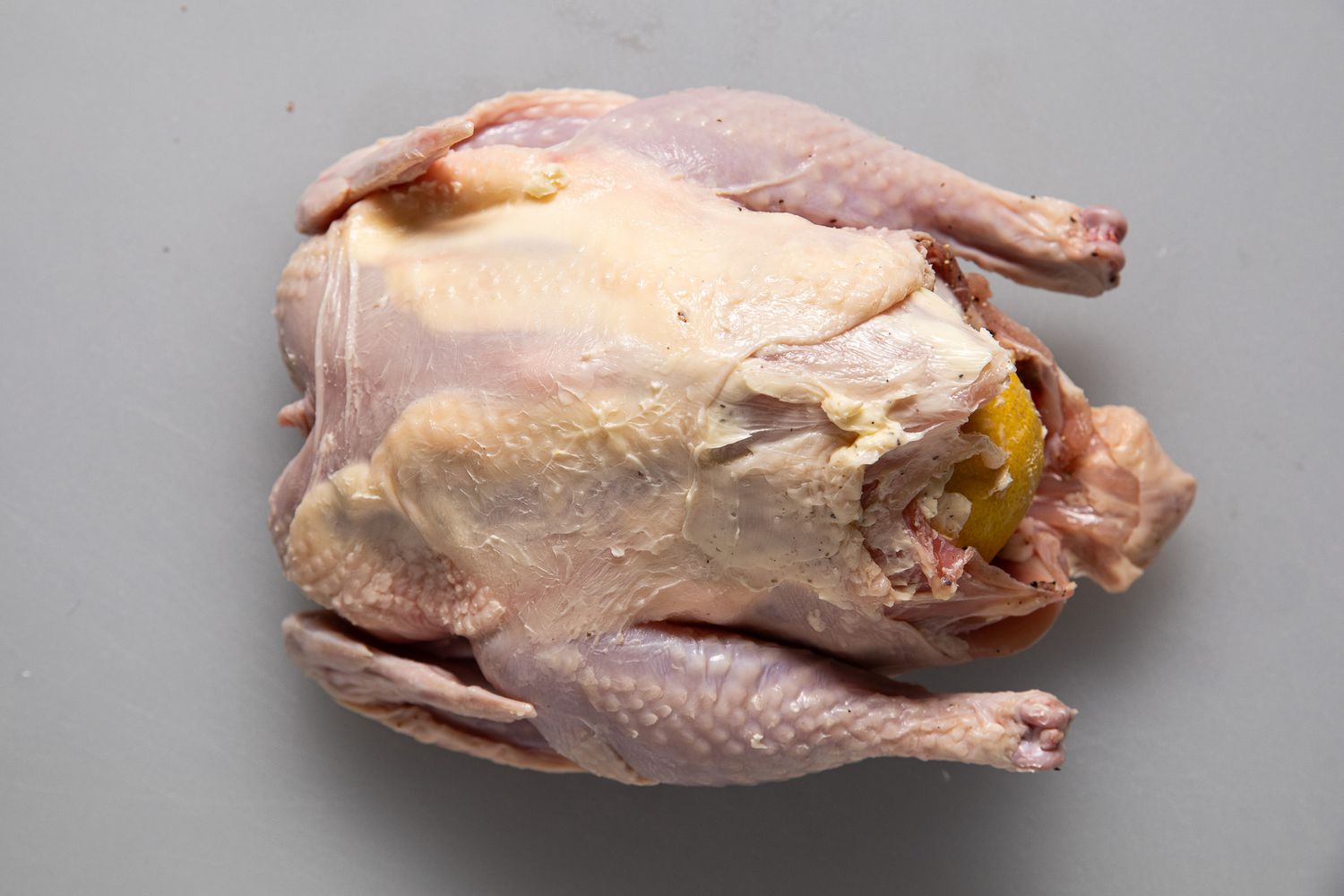 Whole chicken after smeared with butter for roasted chicken recipe